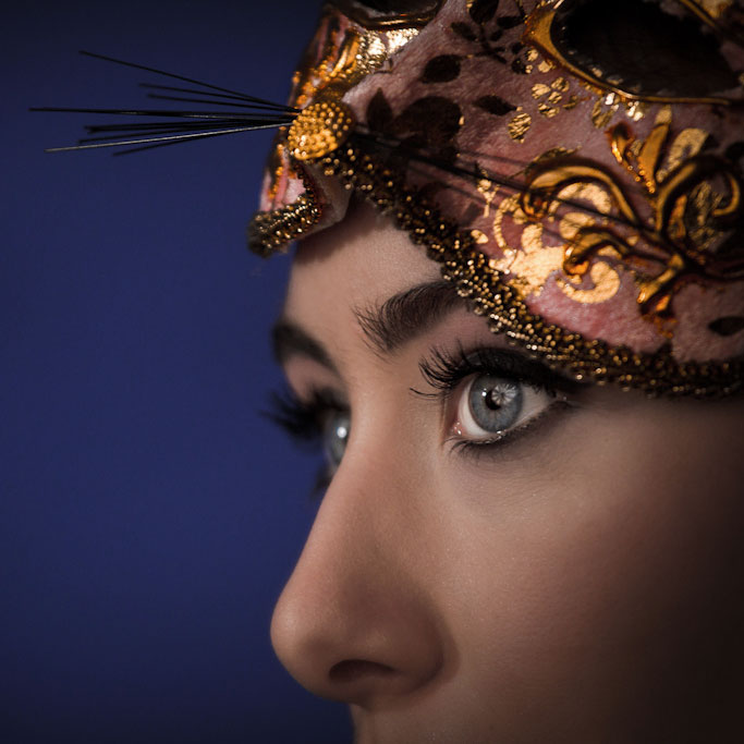 Photograph of a woman in a cat mask